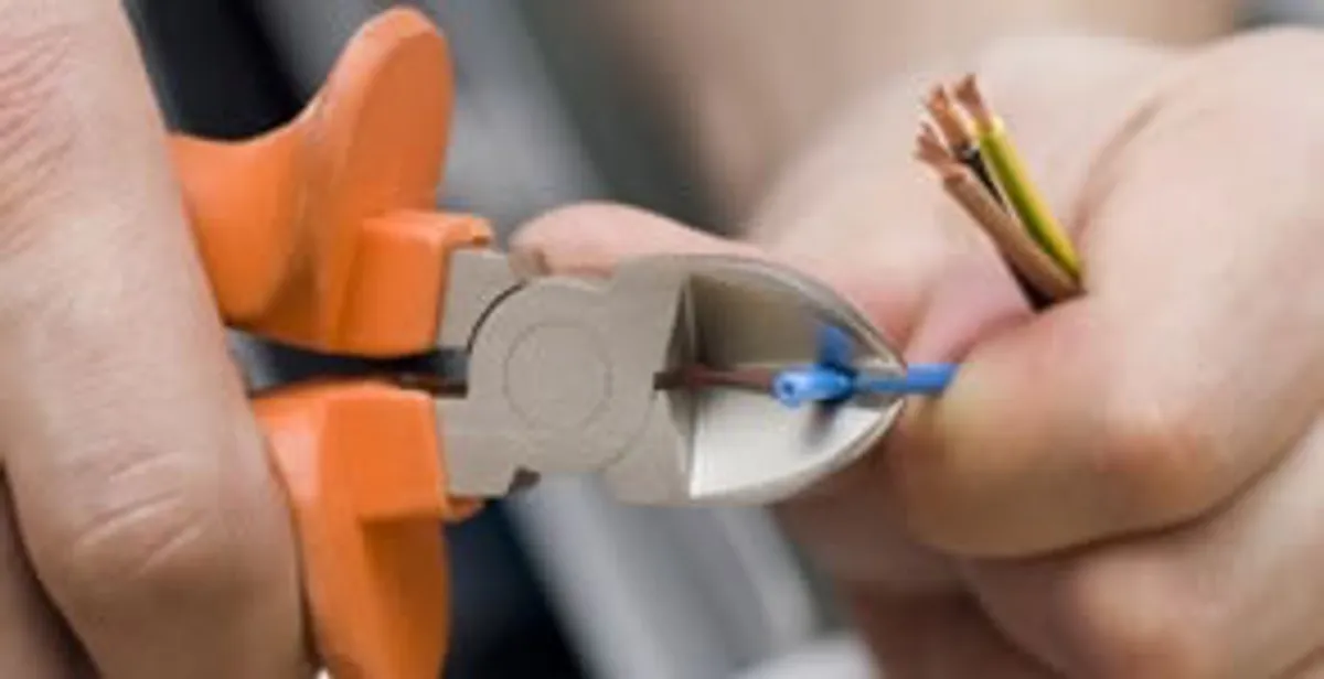 licensed electrician performing precise wire cutting and preparation during electrical service in Columbia, SC